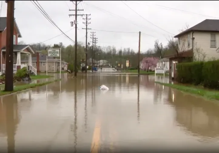 Storm water covering a street and front yards after a heavy downpour